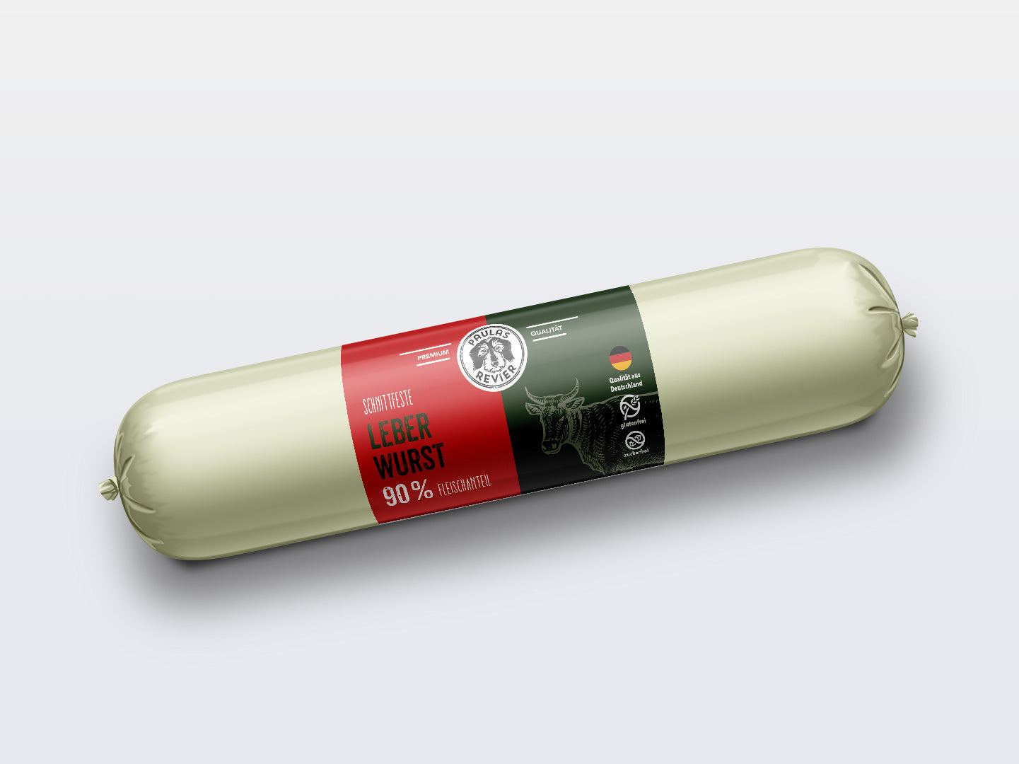 Eine versiegelte Tube Paulas Revier Paulas Leberwurst - 400g Wurst, beschriftet mit "Leberwurst 90% hoher Fleischanteil" mit deutschem Text, einer Kuh-Illustration und einer deutschen Flagge auf einem schwarz-roten Etikett vor weißem Hintergrund.